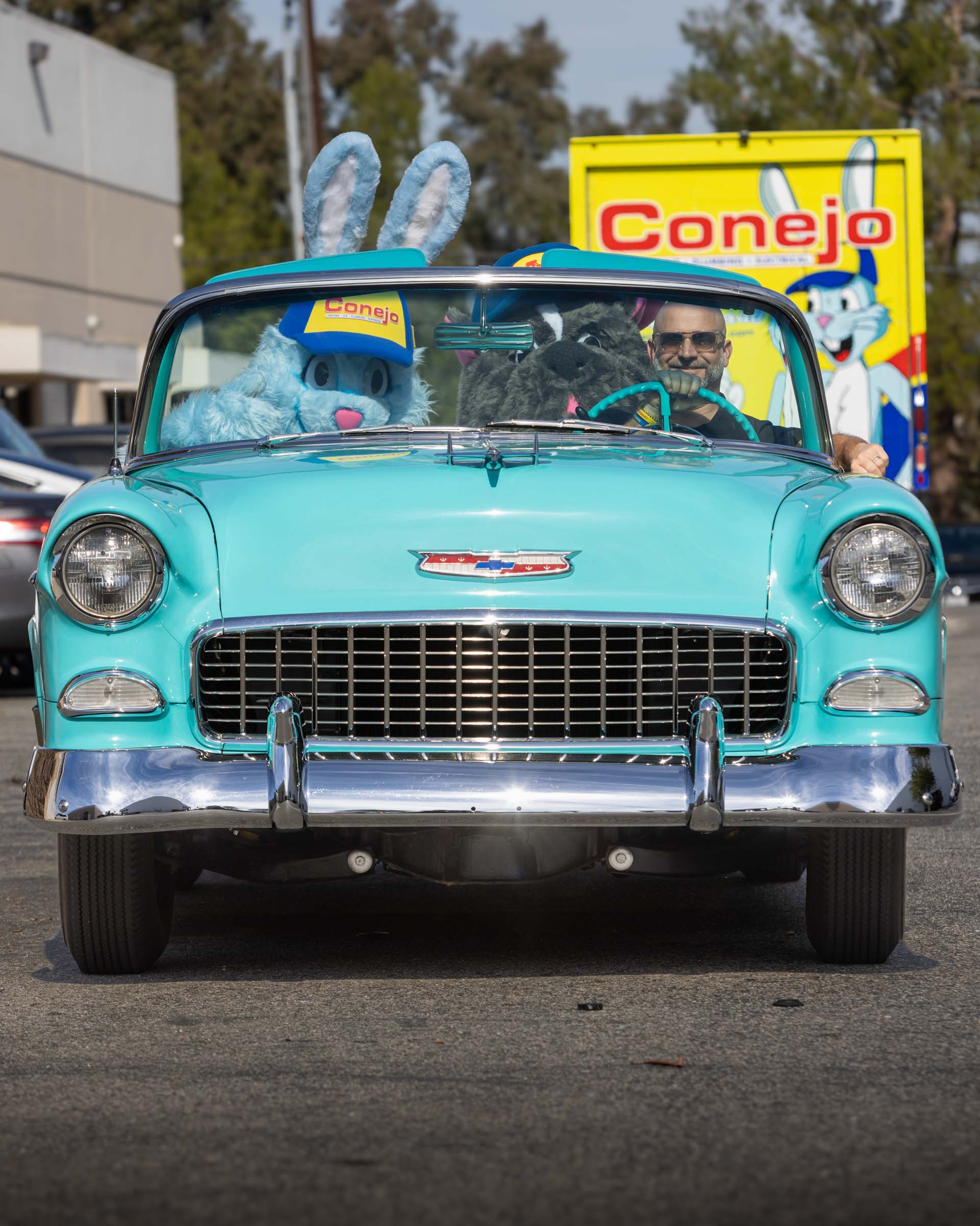 Branden Dickey, CEO, with mascots Gauge the Rabbit (Conejo) and Roofus the Dog (LocalRoofs) in Branden's Bel Air classic car