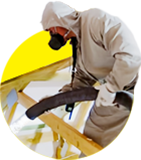 Attic insulation service technician blowing insulation into an attic