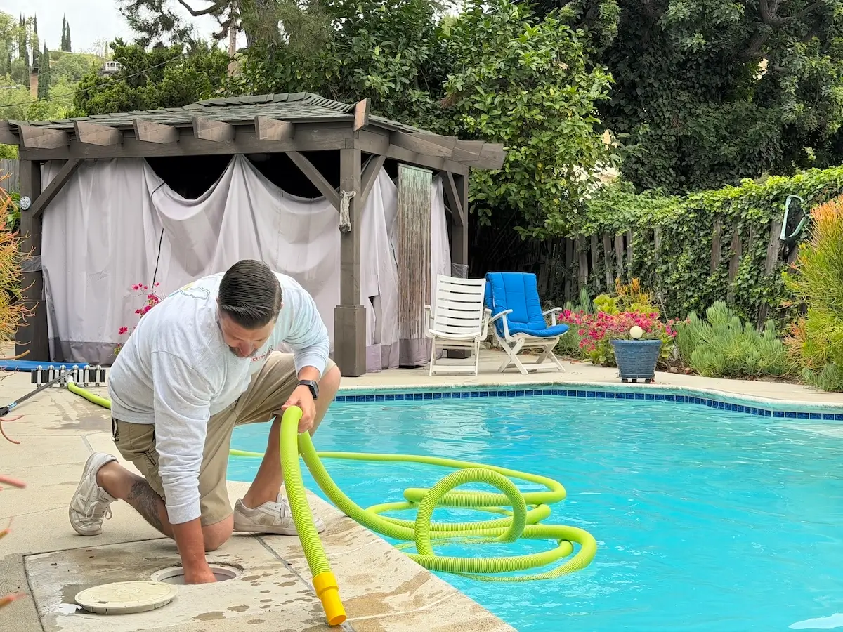 Conejo Services pool technician cleaning a pool and solving common pool problems